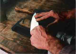 Maikel sharpening a knife